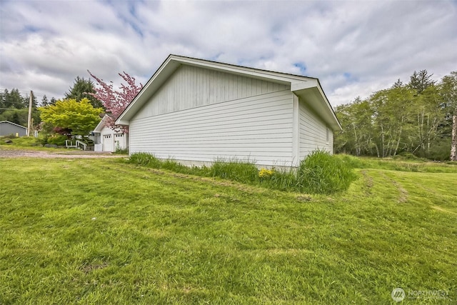 view of side of property with a yard