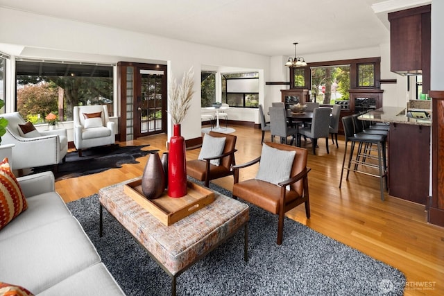 interior space featuring wood finished floors and a notable chandelier