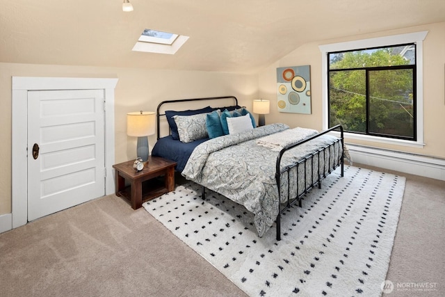 bedroom with carpet and vaulted ceiling with skylight