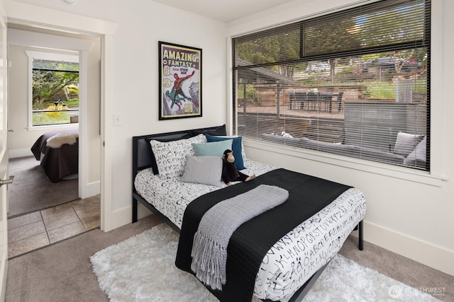 carpeted bedroom featuring baseboards
