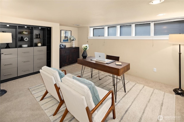 office area featuring light carpet