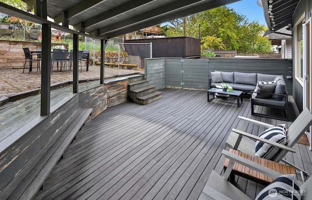 wooden deck featuring a fenced backyard, outdoor dining space, and outdoor lounge area