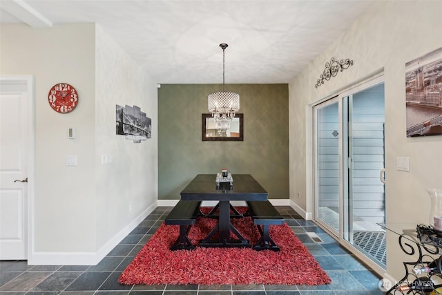 dining room featuring baseboards and an inviting chandelier