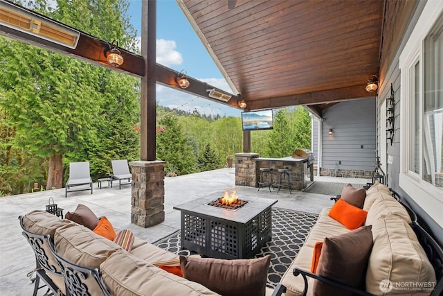view of patio featuring an outdoor living space with a fire pit and outdoor dry bar