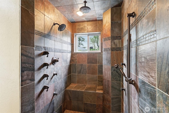 bathroom with a tile shower