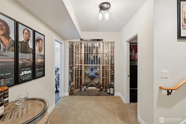 wine area featuring carpet floors and baseboards