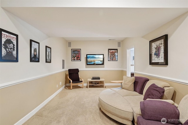 carpeted living room featuring baseboards