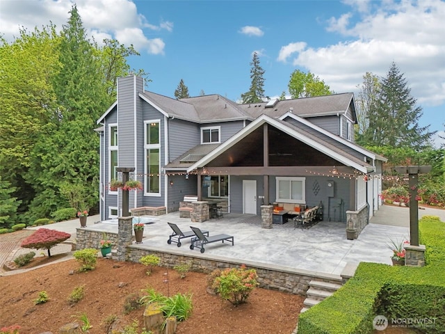 back of house featuring a patio and a chimney