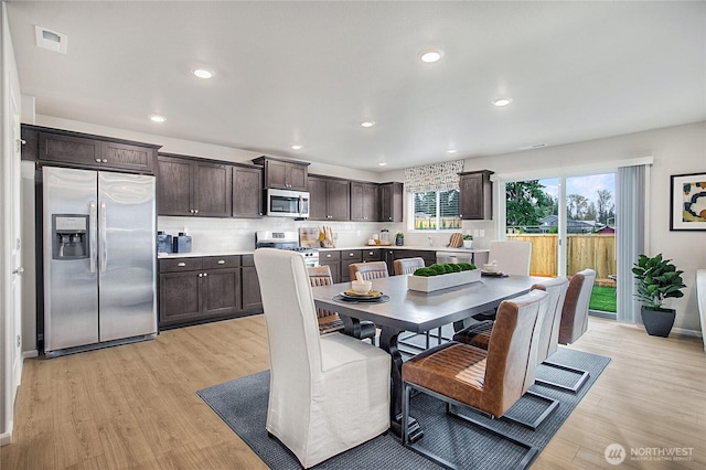 dining room featuring recessed lighting, baseboards, visible vents, and light wood-style flooring