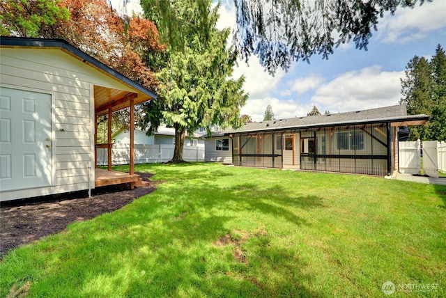 view of yard featuring a fenced backyard and a gate