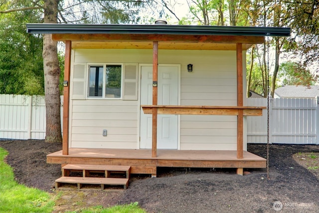 view of outbuilding with fence and an outbuilding