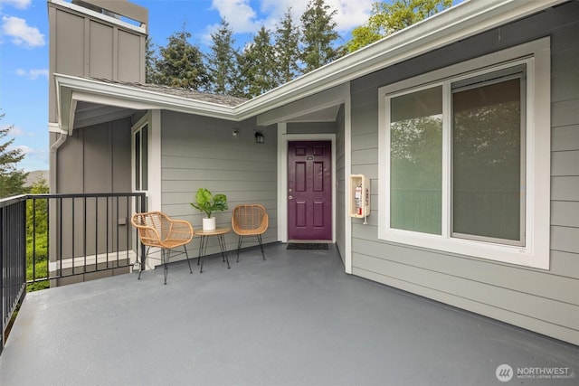 view of exterior entry featuring board and batten siding and a porch