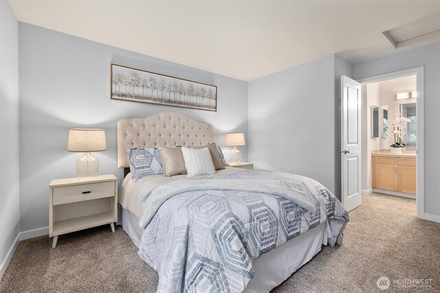 bedroom featuring baseboards, light carpet, and attic access