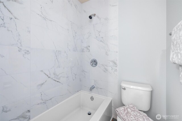 bathroom featuring toilet and  shower combination