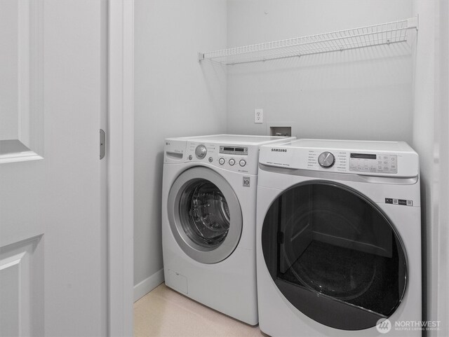 laundry area featuring laundry area, baseboards, and washing machine and dryer