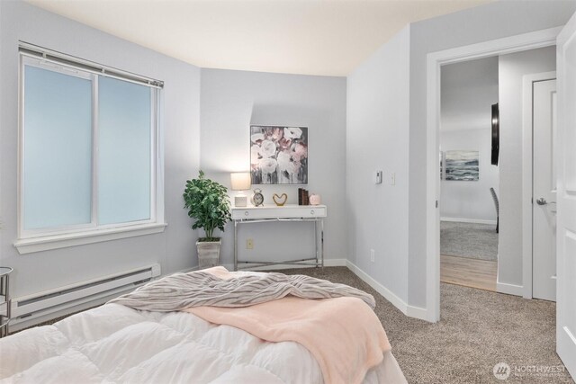 carpeted bedroom with baseboards and a baseboard heating unit