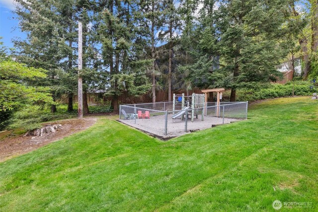view of yard featuring fence and a playground