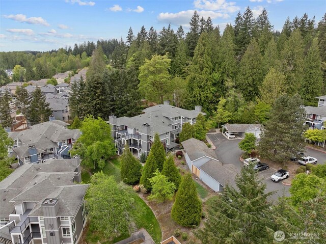 drone / aerial view with a residential view and a view of trees