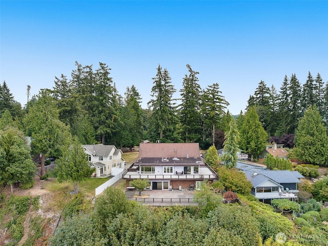 drone / aerial view featuring a wooded view