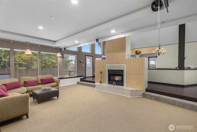 living room with carpet floors, plenty of natural light, recessed lighting, and a tile fireplace