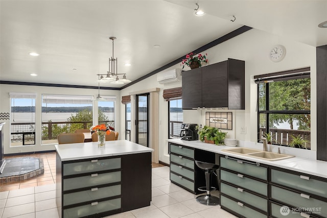 kitchen featuring lofted ceiling, light tile patterned flooring, an AC wall unit, light countertops, and a sink