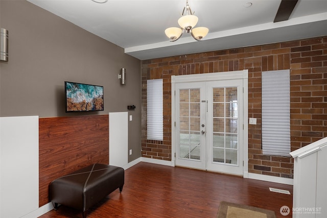 doorway to outside with baseboards, visible vents, french doors, and wood finished floors
