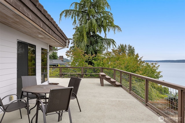 view of patio / terrace with a water view and outdoor dining space