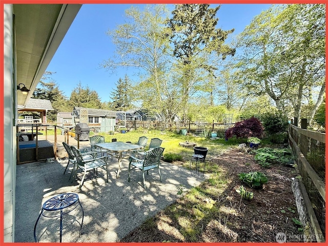 view of patio / terrace with a fenced backyard, an outdoor fire pit, and outdoor dining area