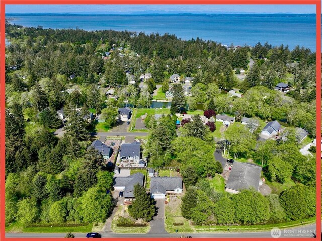aerial view of property's location featuring nearby suburban area and a large body of water
