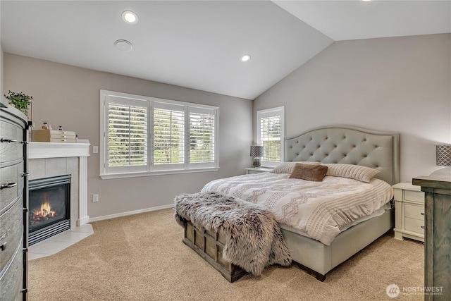 bedroom with recessed lighting, a fireplace, lofted ceiling, and light carpet