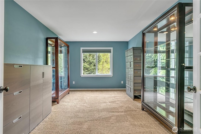 corridor featuring carpet floors, baseboards, and recessed lighting