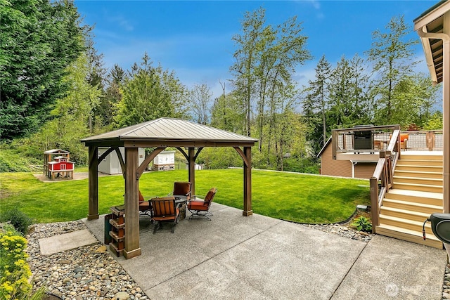 view of patio / terrace with a deck, a gazebo, an outdoor fire pit, and stairway