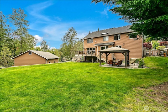 rear view of property with a gazebo, a lawn, and a patio