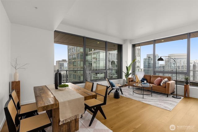 sunroom / solarium featuring a view of city and plenty of natural light