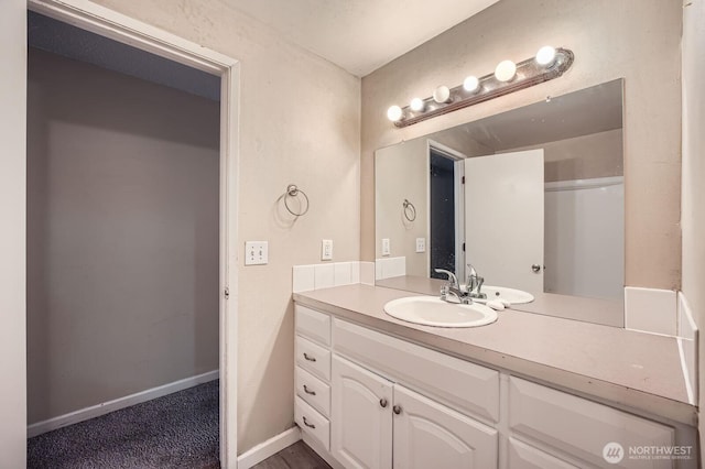 bathroom with vanity and baseboards