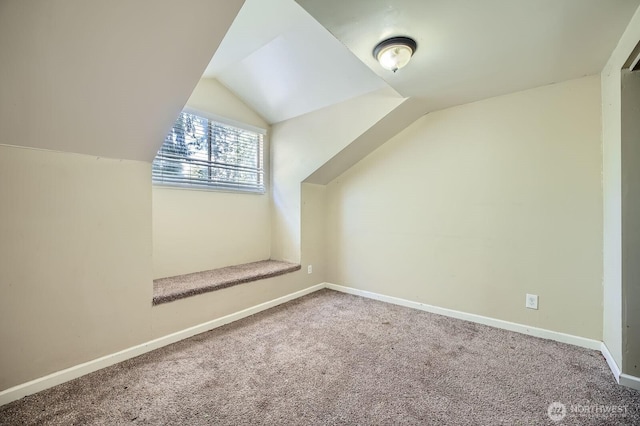 bonus room featuring carpet flooring, baseboards, and lofted ceiling