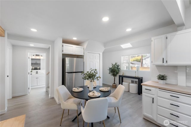 916 S Sheridan Ave, Tacoma, WA 98405 - dining space with recessed lighting, light wood finished floors, and a skylight