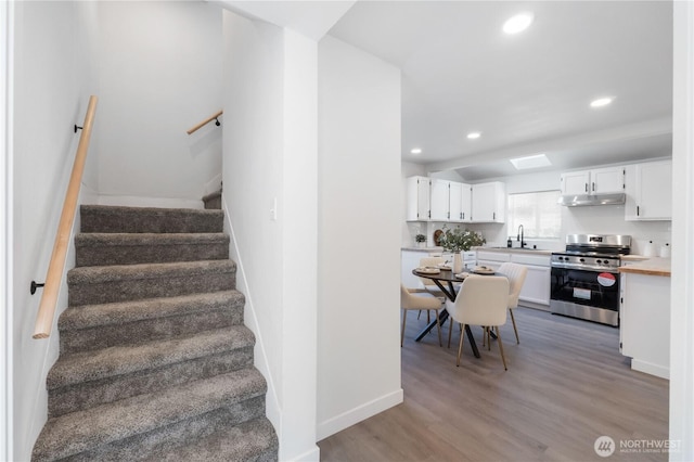 916 S Sheridan Ave, Tacoma, WA 98405 - stairs featuring recessed lighting and wood finished floors
