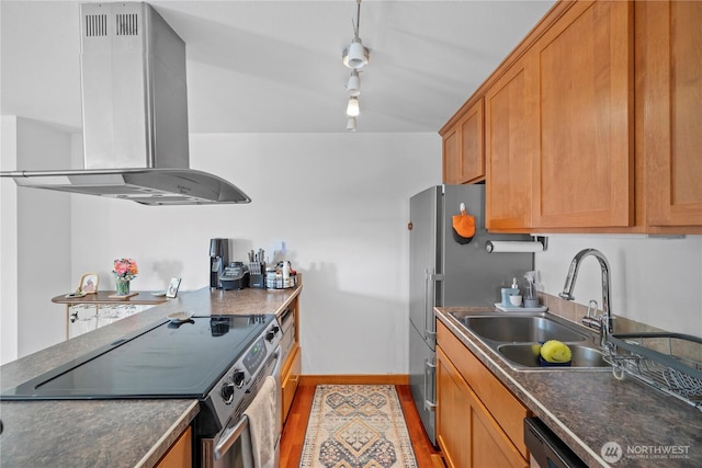 kitchen featuring dark countertops, track lighting, a sink, electric stove, and island exhaust hood