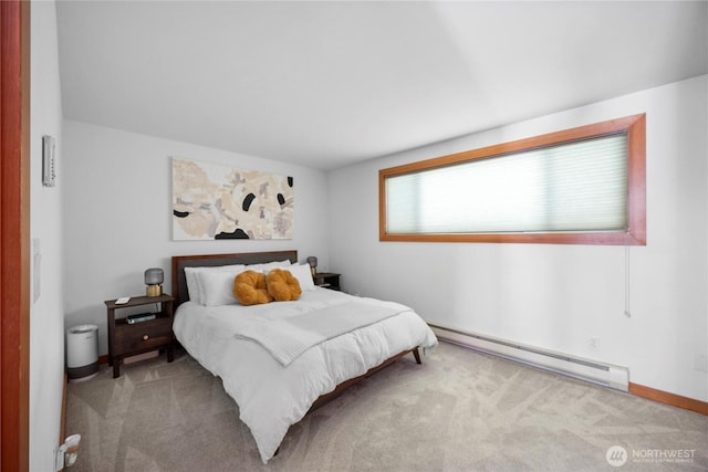 carpeted bedroom with baseboards and a baseboard heating unit
