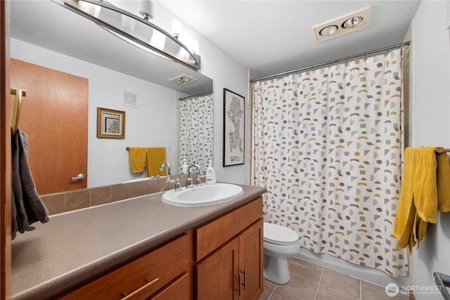 bathroom with tile patterned flooring, visible vents, toilet, and vanity