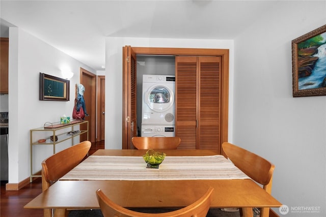 dining area featuring stacked washer and clothes dryer and wood finished floors