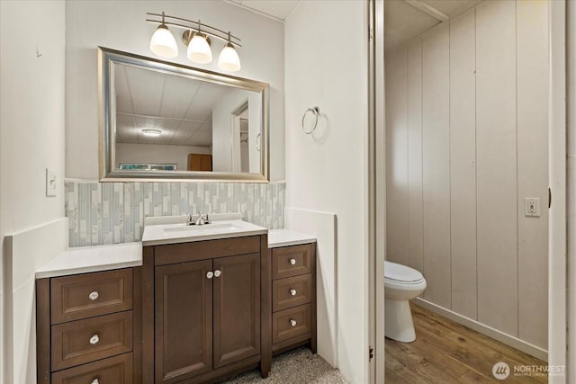 19003 129th Ave NE, Bothell, WA 98011 - bathroom with wood finished floors, toilet, vanity, and backsplash