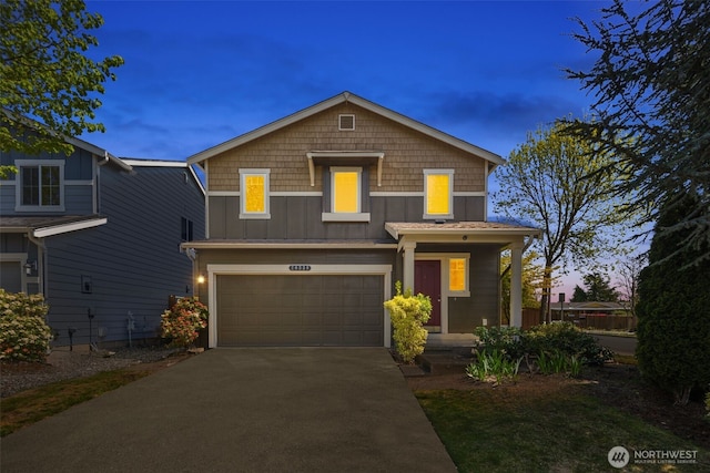 traditional-style home with an attached garage, aphalt driveway, and board and batten siding