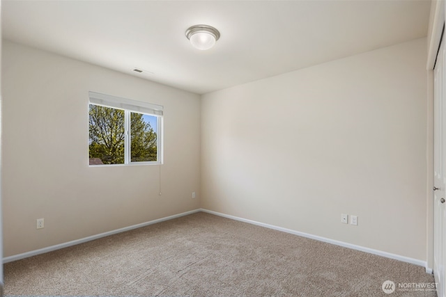 empty room with baseboards and carpet