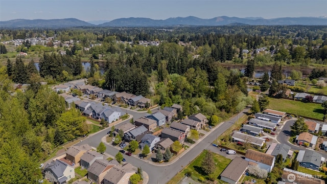 bird's eye view with a water and mountain view, a residential view, and a wooded view