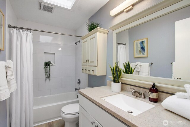 bathroom with visible vents, shower / tub combo with curtain, toilet, and vanity