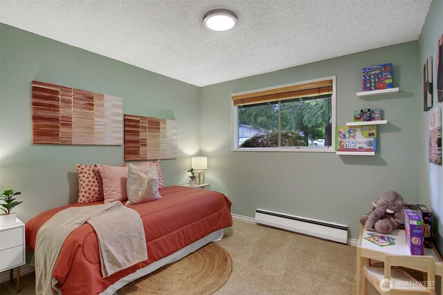 carpeted bedroom featuring baseboards, baseboard heating, and a textured ceiling