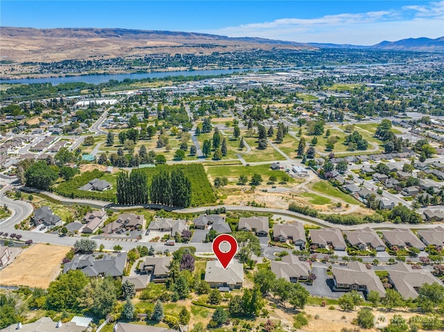aerial view with a water and mountain view and a residential view
