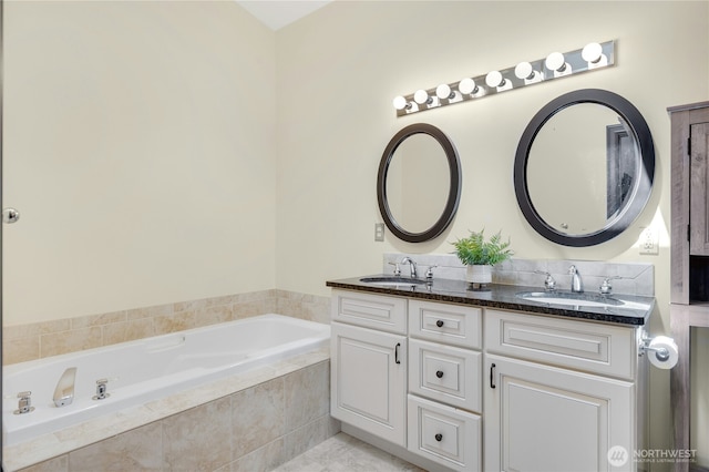 full bath featuring double vanity, a sink, and a garden tub